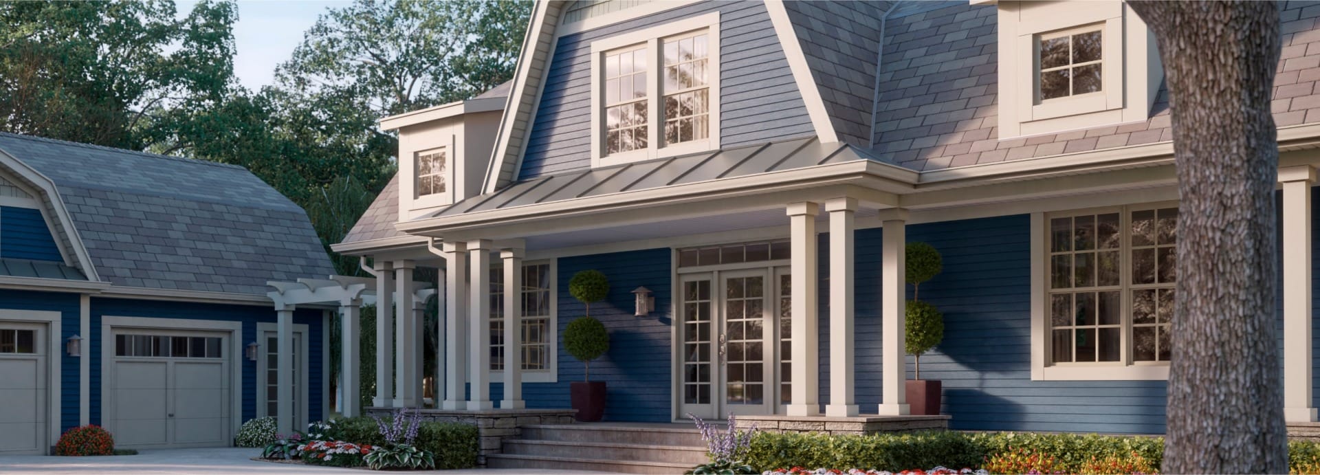 Beautiful blue house with white trim and front porch, surrounded by trees and landscaping.